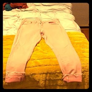 Pink, lightly distressed Mid-rise skinny jeans